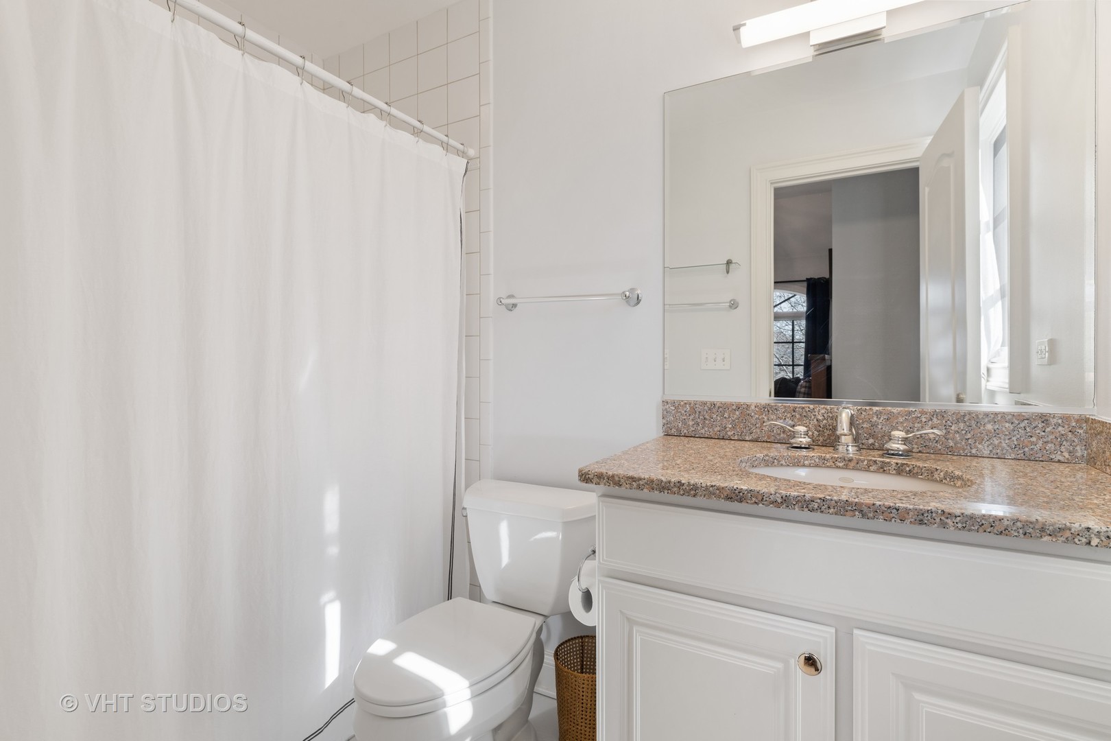 795 Grove Street Glencoe, IL 60022 - Photo 23 of 38 a bathroom with a granite countertop sink and a mirror