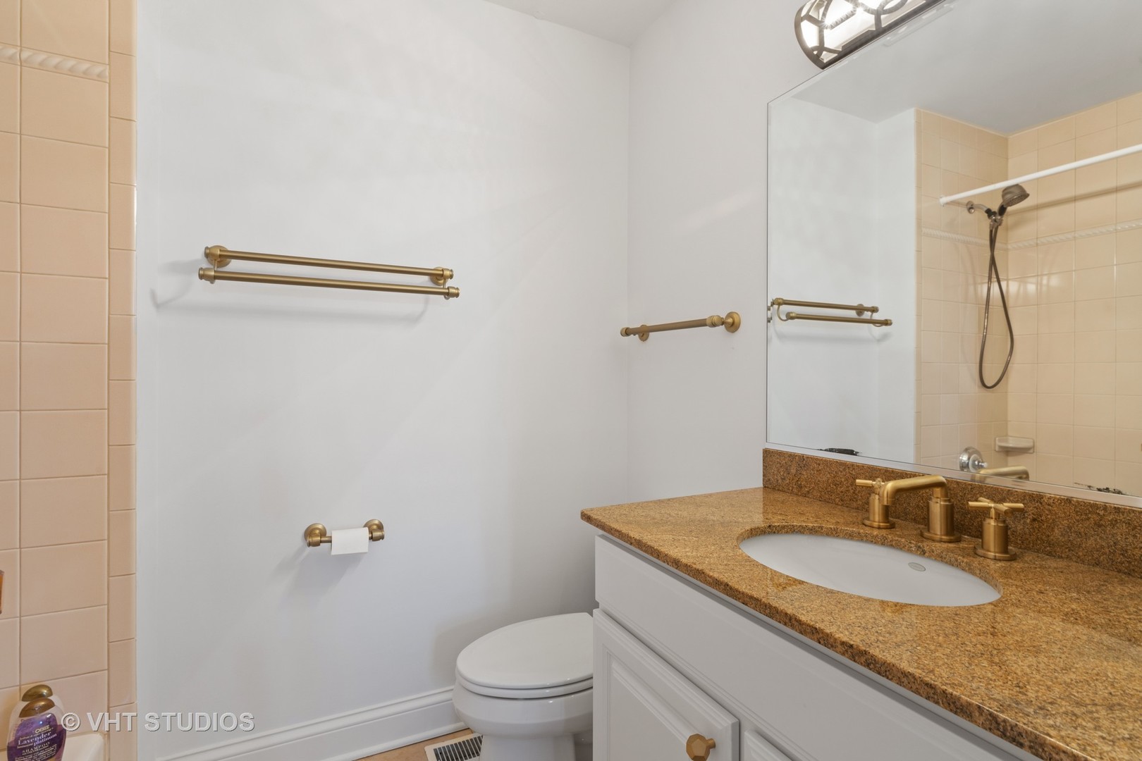 795 Grove Street Glencoe, IL 60022 - Photo 25 of 38 a bathroom with a granite countertop sink a toilet and a mirror