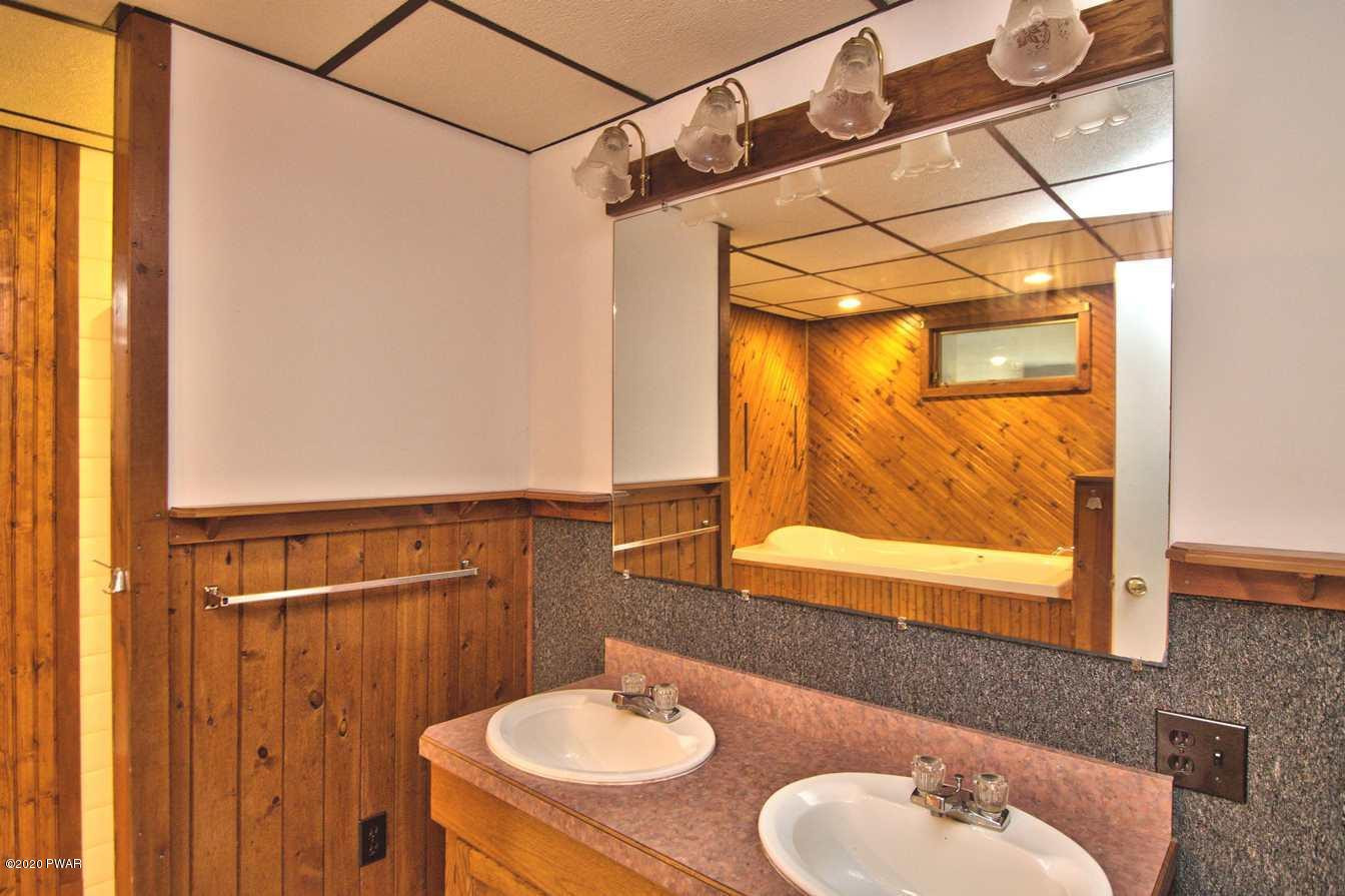 5690 Haas Pond Road Moscow, PA 18444 - Photo 26 of 79 a bathroom with a sink and a mirror