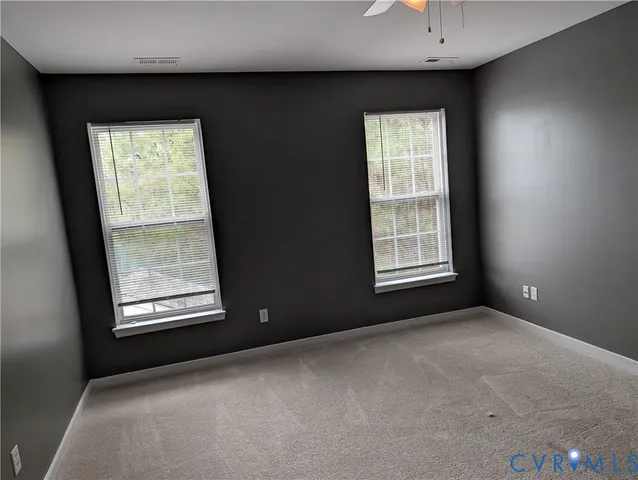 a white toilet sitting next to a window