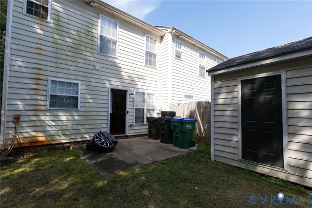 a view of backyard and wooden fence