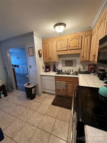 a view of a yard with table and chairs under an umbrella