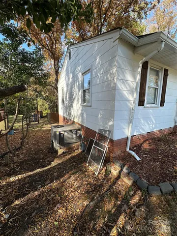 a backyard of a house with table and chairs
