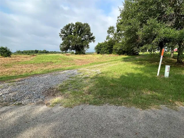 a view of a field with an ocean view