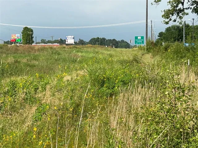 a view of a field with an trees