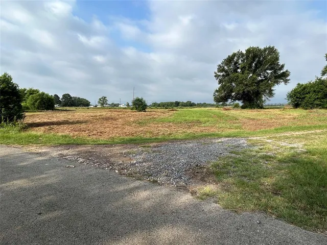 a view of a field with sitting area