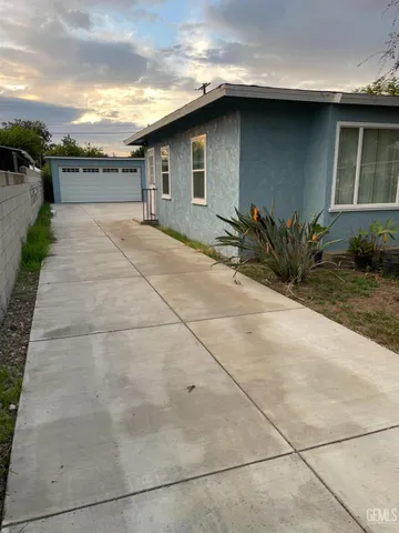a pathway of a house with a yard