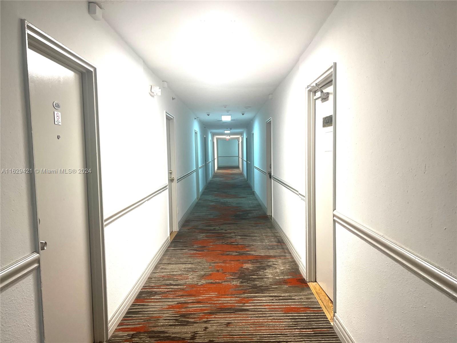 6345 Collins Avenue, Unit 635 Miami Beach, FL 33141 - Photo 11 of 28 a view of a hallway with wooden floor