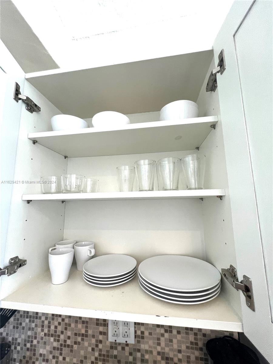 6345 Collins Avenue, Unit 635 Miami Beach, FL 33141 - Photo 17 of 28 a bathroom with a sink a toilet and a shower curtain