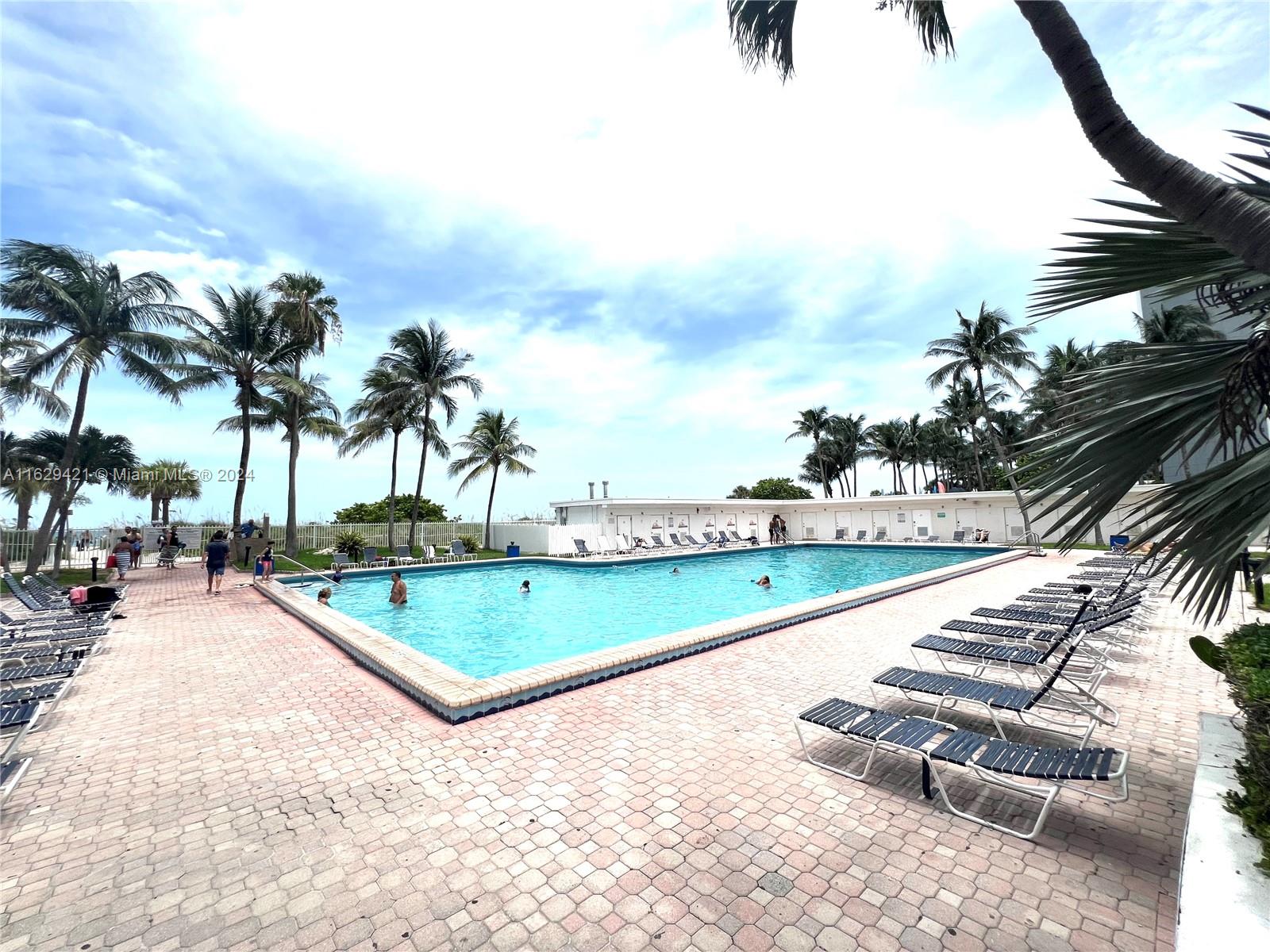 6345 Collins Avenue, Unit 635 Miami Beach, FL 33141 - Photo 21 of 28 a view of swimming pool with outdoor seating and plants