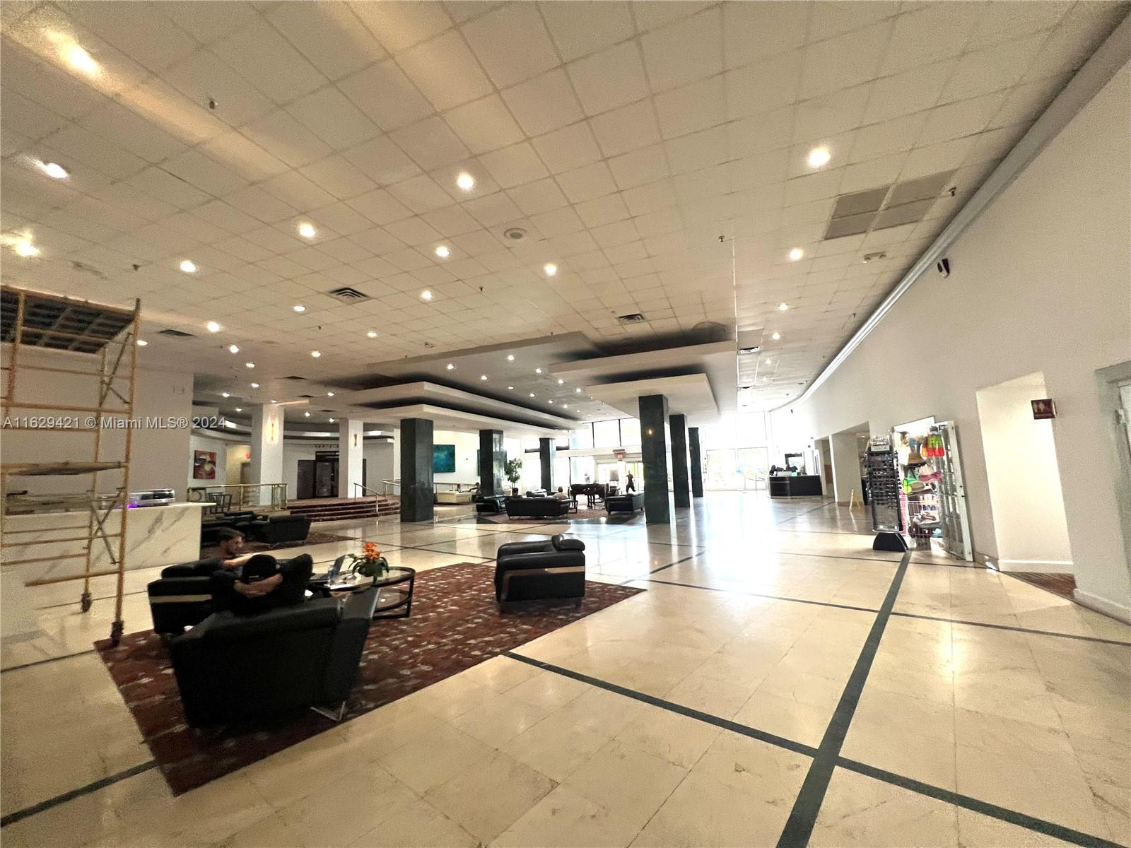 6345 Collins Avenue, Unit 635 Miami Beach, FL 33141 - Photo 25 of 28 a living room with furniture and a flat screen tv