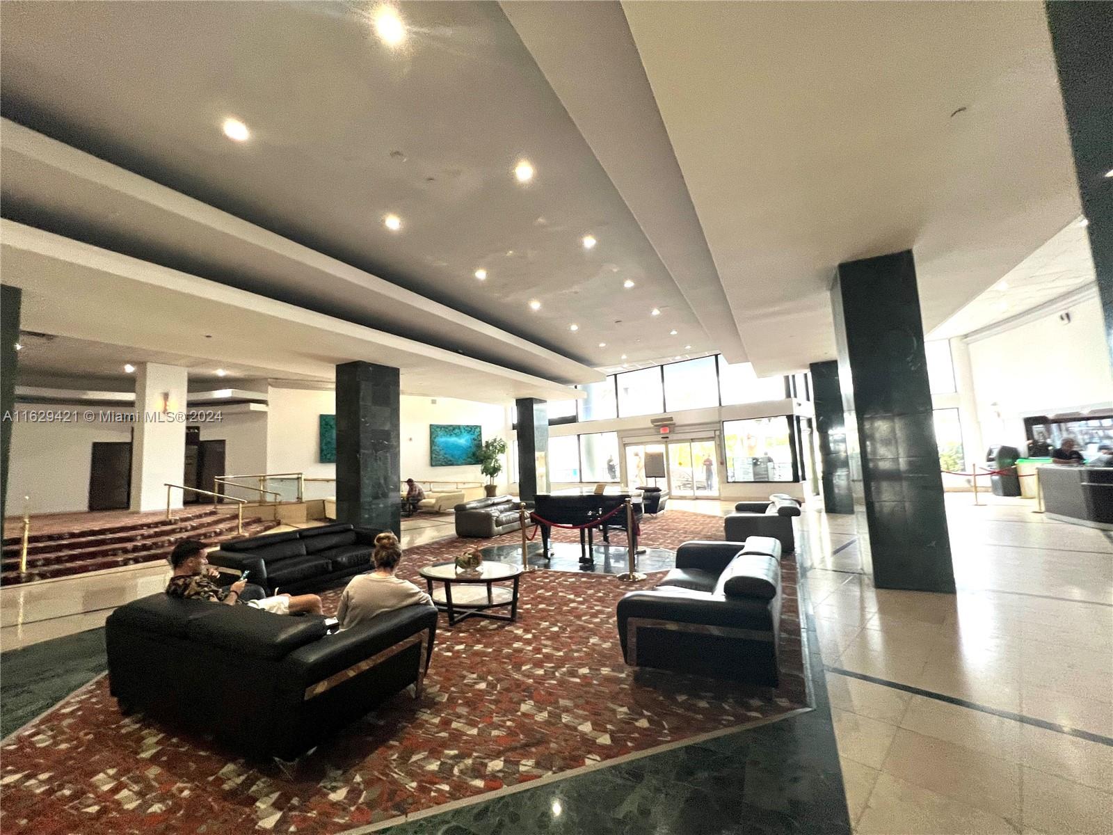 6345 Collins Avenue, Unit 635 Miami Beach, FL 33141 - Photo 26 of 28 a living room with furniture and a large window