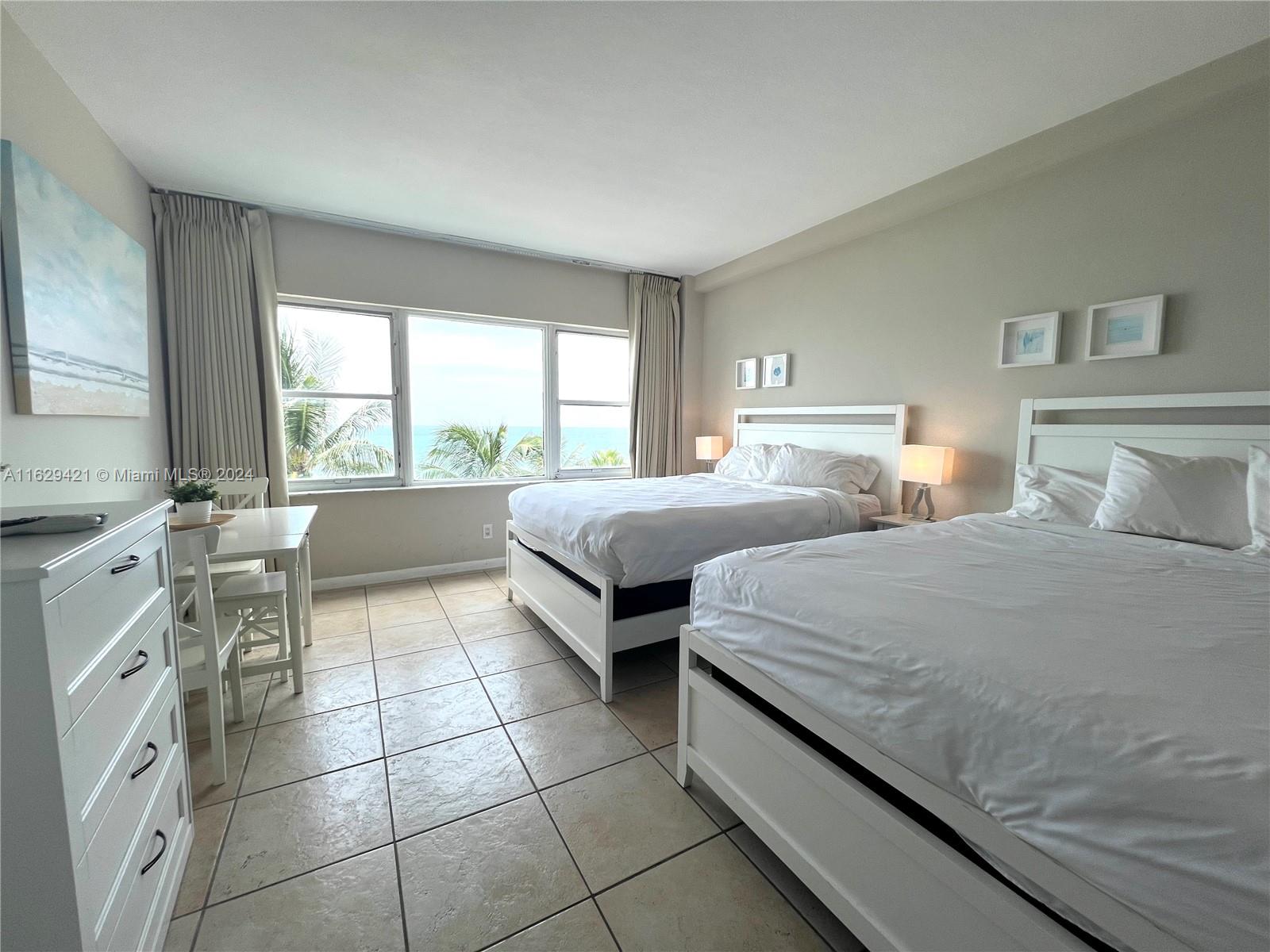 6345 Collins Avenue, Unit 635 Miami Beach, FL 33141 - Photo 4 of 28 a bedroom with double bed and a window