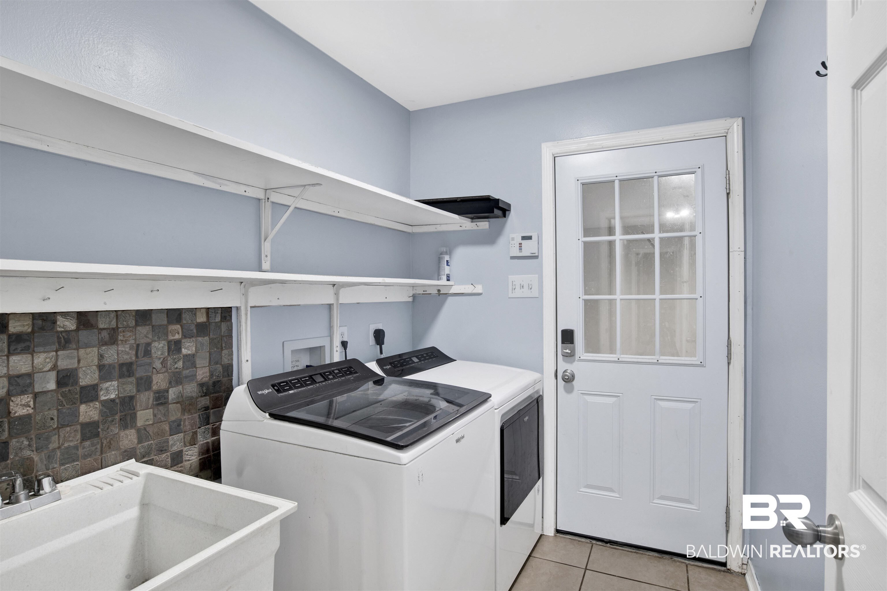 9534 Labrador Run North Mobile, AL 36695 - Photo 21 of 30 Washroom featuring light tile patterned flooring and washing machine and clothes dryer