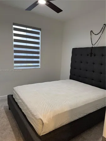 a bedroom with bed and window
