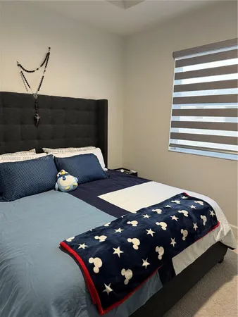 a bedroom with a bed and window