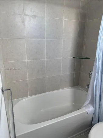 a white bath tub and a sink