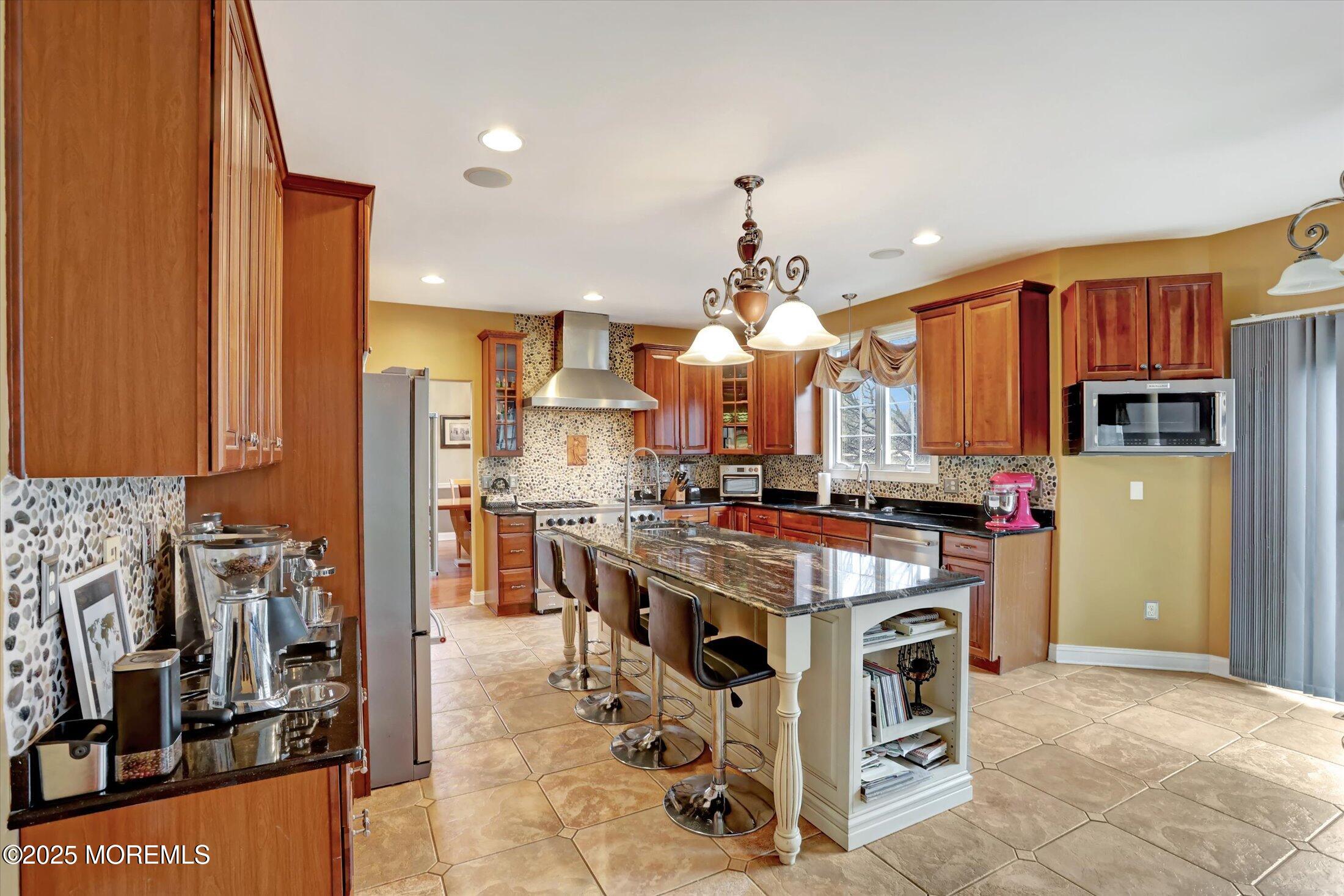 330 Randolph Road Freehold, NJ 07728 - Photo 11 of 63 a kitchen with stainless steel appliances granite countertop a stove top oven a refrigerator a sink and dishwasher