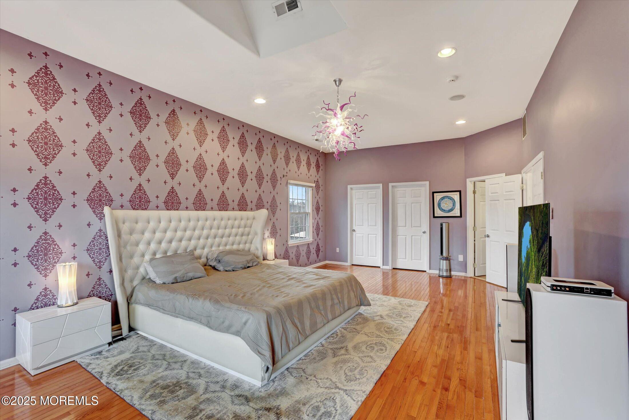 330 Randolph Road Freehold, NJ 07728 - Photo 14 of 63 a spacious bedroom with a large bed and a chandelier