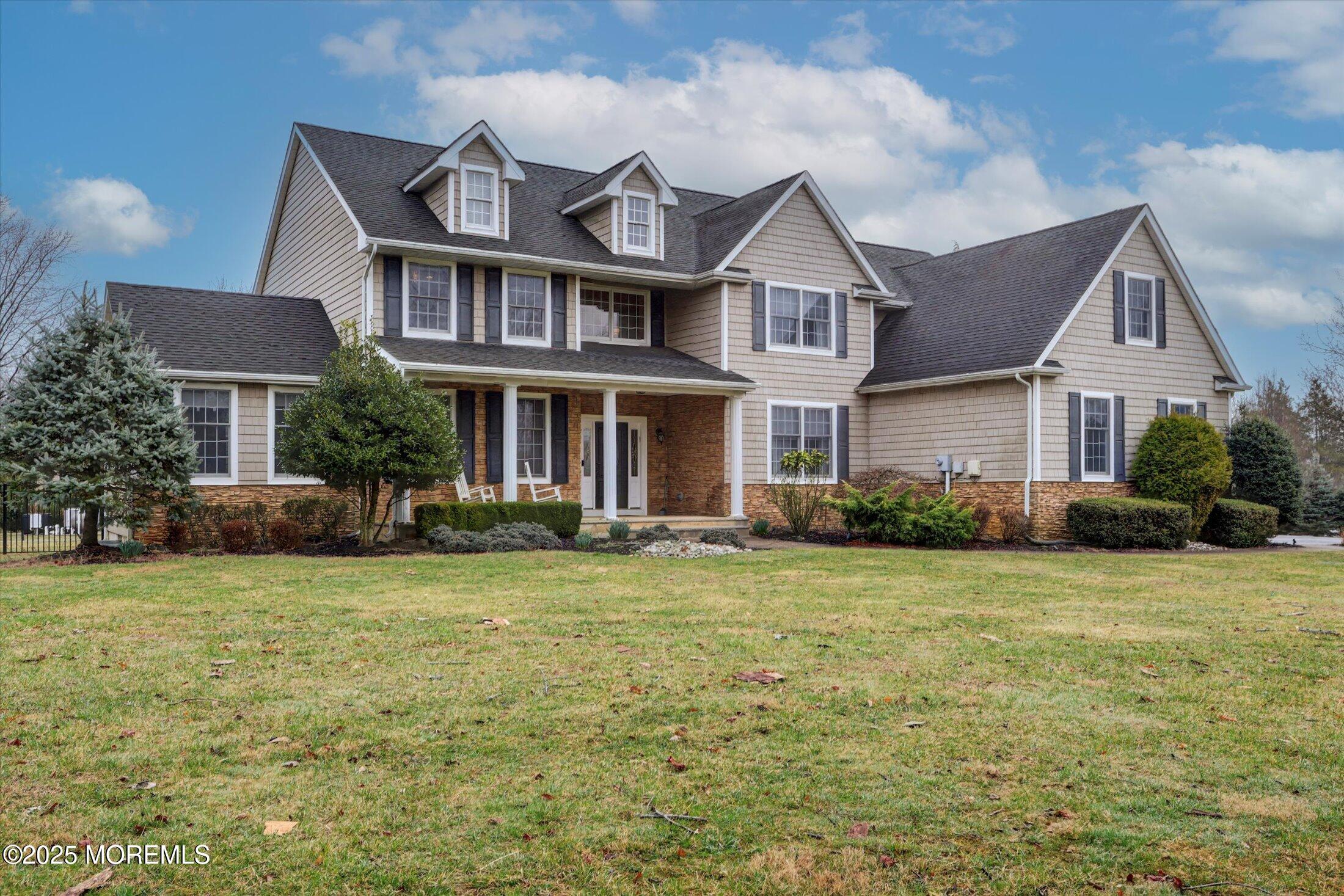 330 Randolph Road Freehold, NJ 07728 - Photo 3 of 63 a front view of a house with a garden