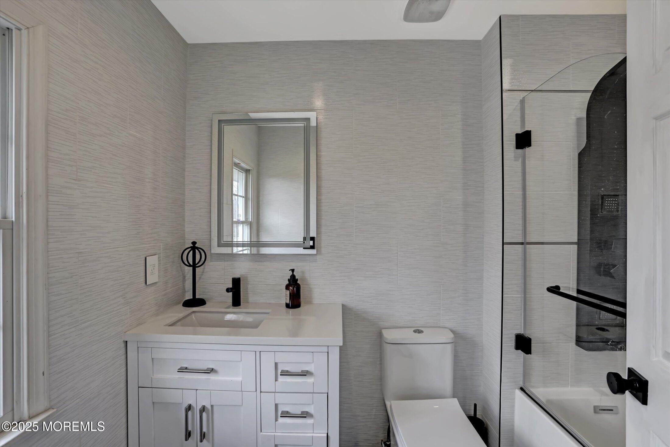 330 Randolph Road Freehold, NJ 07728 - Photo 32 of 63 a bathroom with a toilet sink vanity and shower