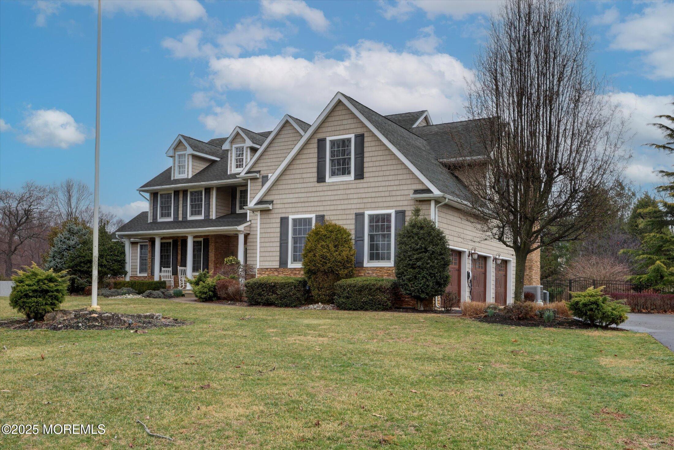 330 Randolph Road Freehold, NJ 07728 - Photo 4 of 63 a front view of a house with a yard