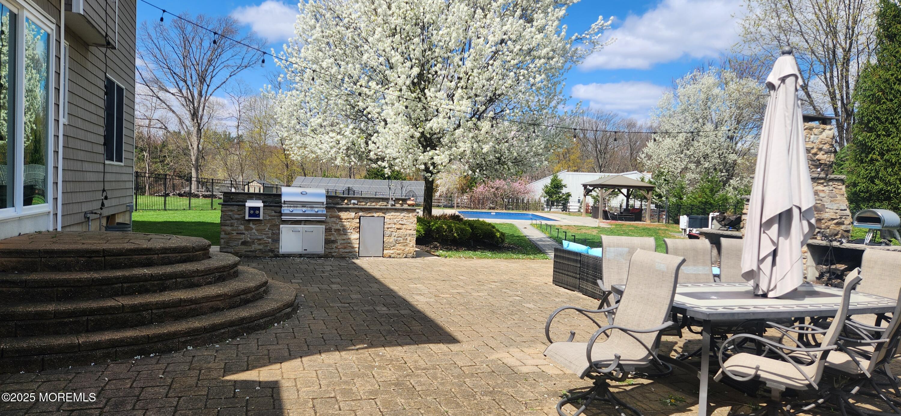 330 Randolph Road Freehold, NJ 07728 - Photo 41 of 63 a view of a patio with couches table and chairs and potted plants