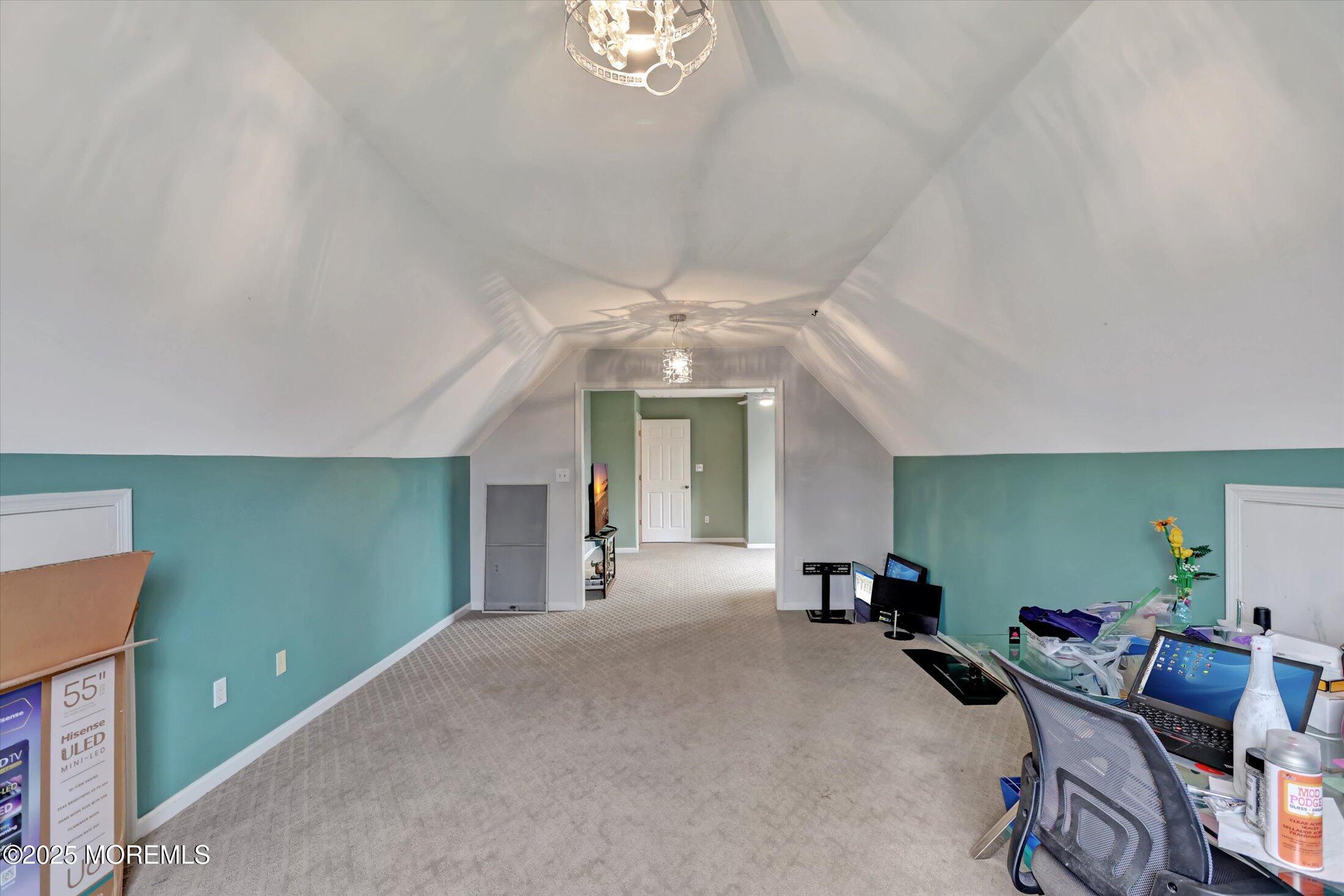 330 Randolph Road Freehold, NJ 07728 - Photo 47 of 63 a living room with furniture and a chandelier