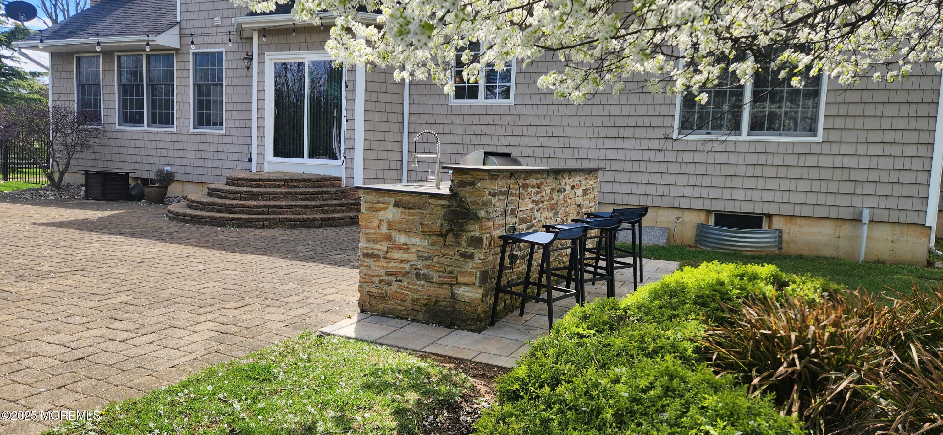 330 Randolph Road Freehold, NJ 07728 - Photo 59 of 63 a view of a patio with table and chairs and potted plants