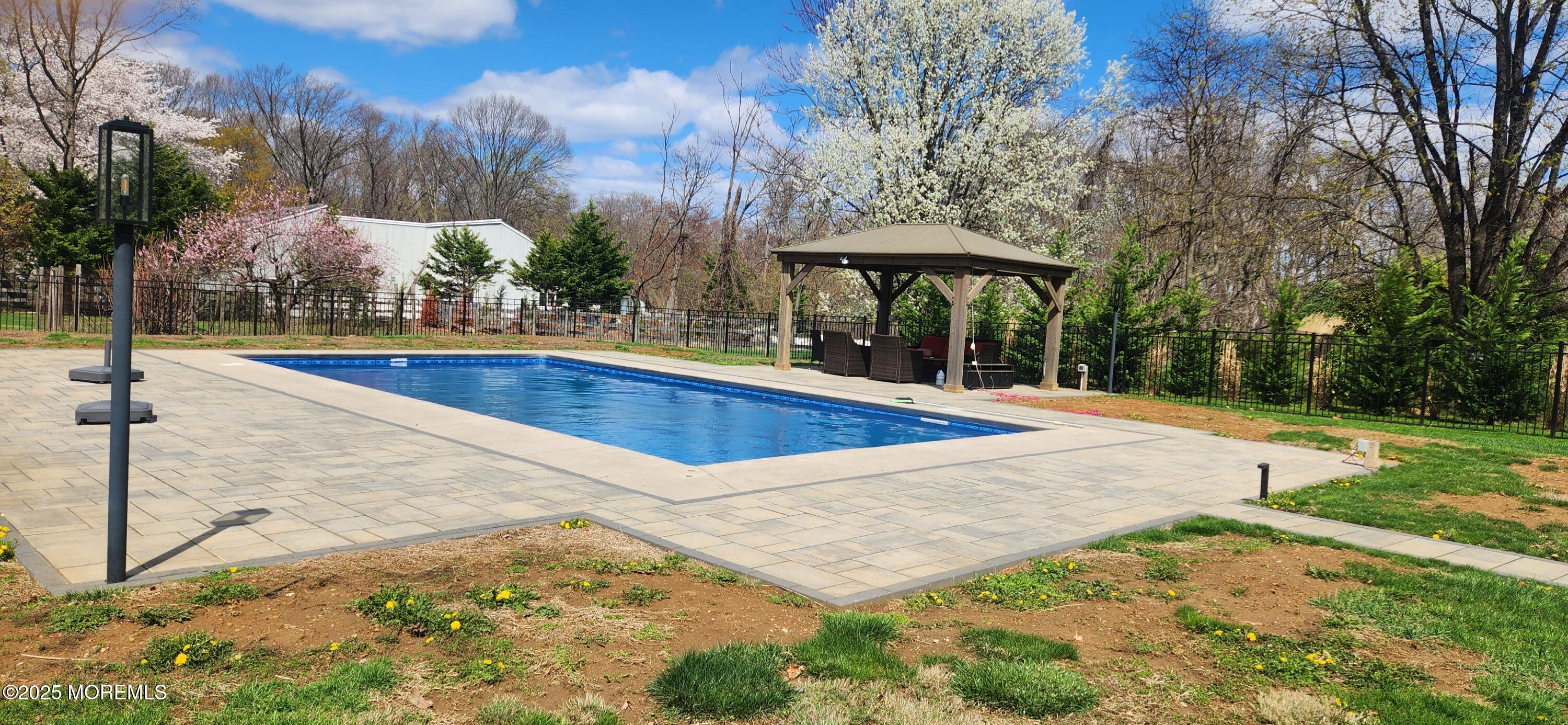 330 Randolph Road Freehold, NJ 07728 - Photo 61 of 63 a view of a swimming pool with an outdoor space and seating area