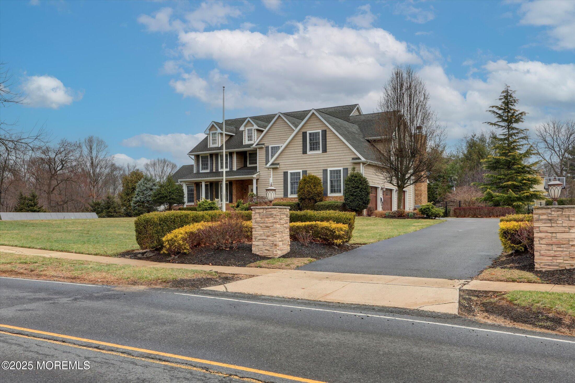 330 Randolph Road Freehold, NJ 07728 - Photo 7 of 63 a view of a house with a big yard and large trees