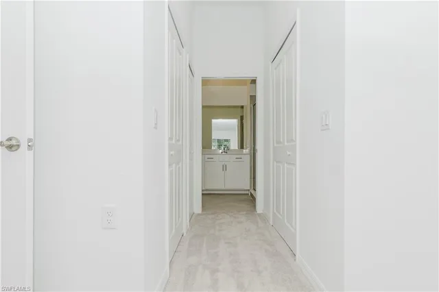 a view of a hallway with a wooden shelves