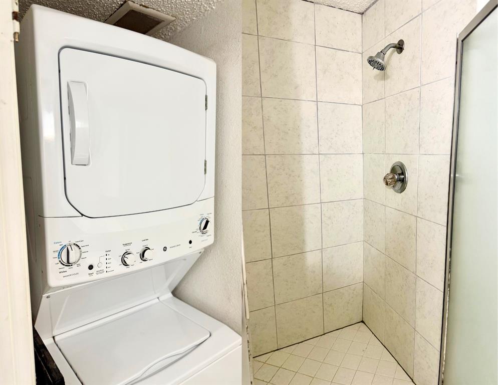 9803 Walnut Street, Unit 308 Dallas, TX 75243 - Photo 13 of 13 Laundry room with stacked washer and clothes dryer