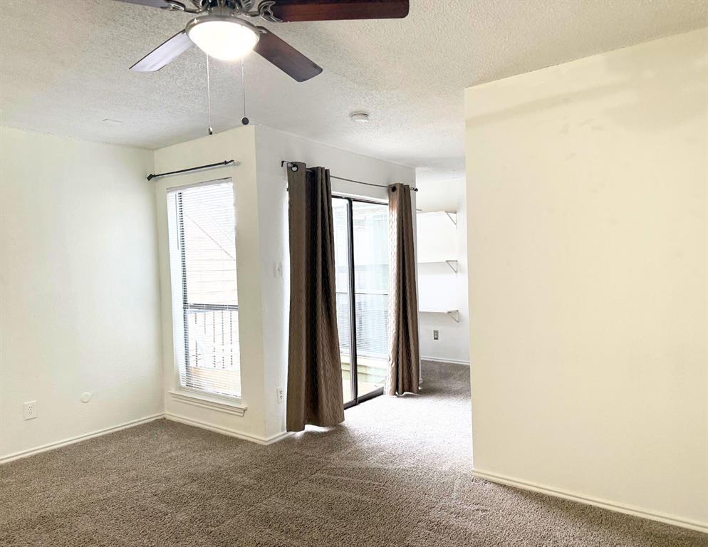 9803 Walnut Street, Unit 308 Dallas, TX 75243 - Photo 6 of 13 Empty room featuring baseboards, carpet floors, a textured ceiling, and ceiling fan