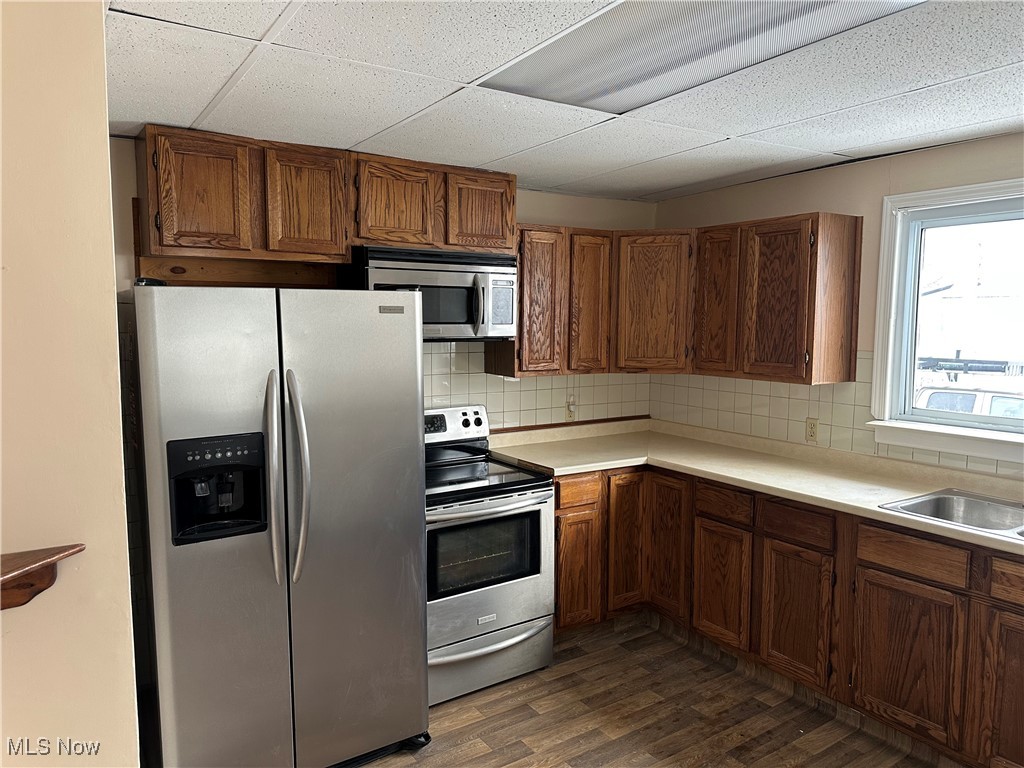 60 Taylor Road Barberton, OH 44203 - Photo 4 of 35 Kitchen featuring sink, stainless steel appliances, dark hardwood / wood-style flooring, a paneled ceiling, and decorative backsplash