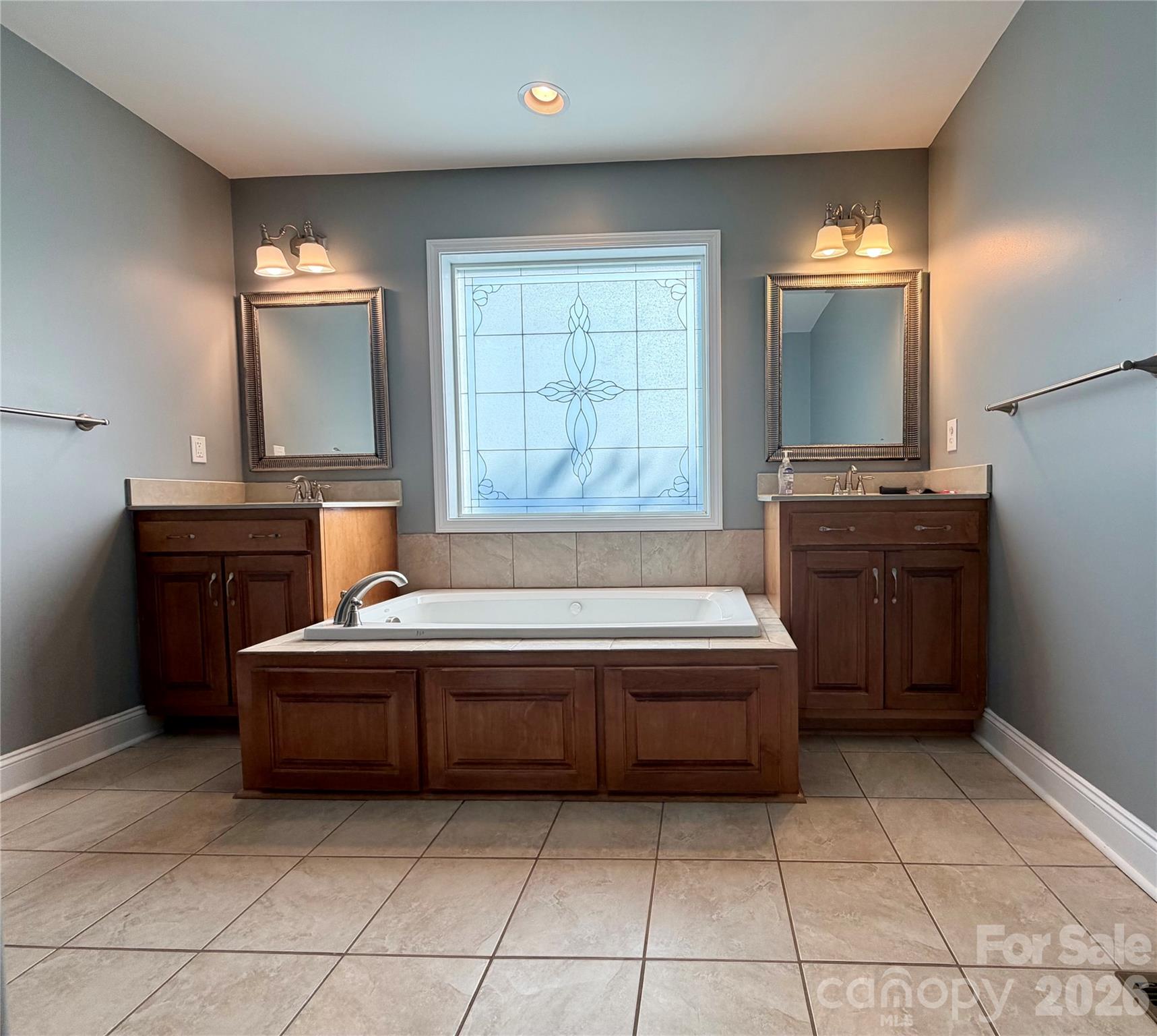 510 East Carpenter Street Maiden, NC 28650 - Photo 11 of 20 a spacious bathroom with a tub sink and mirror