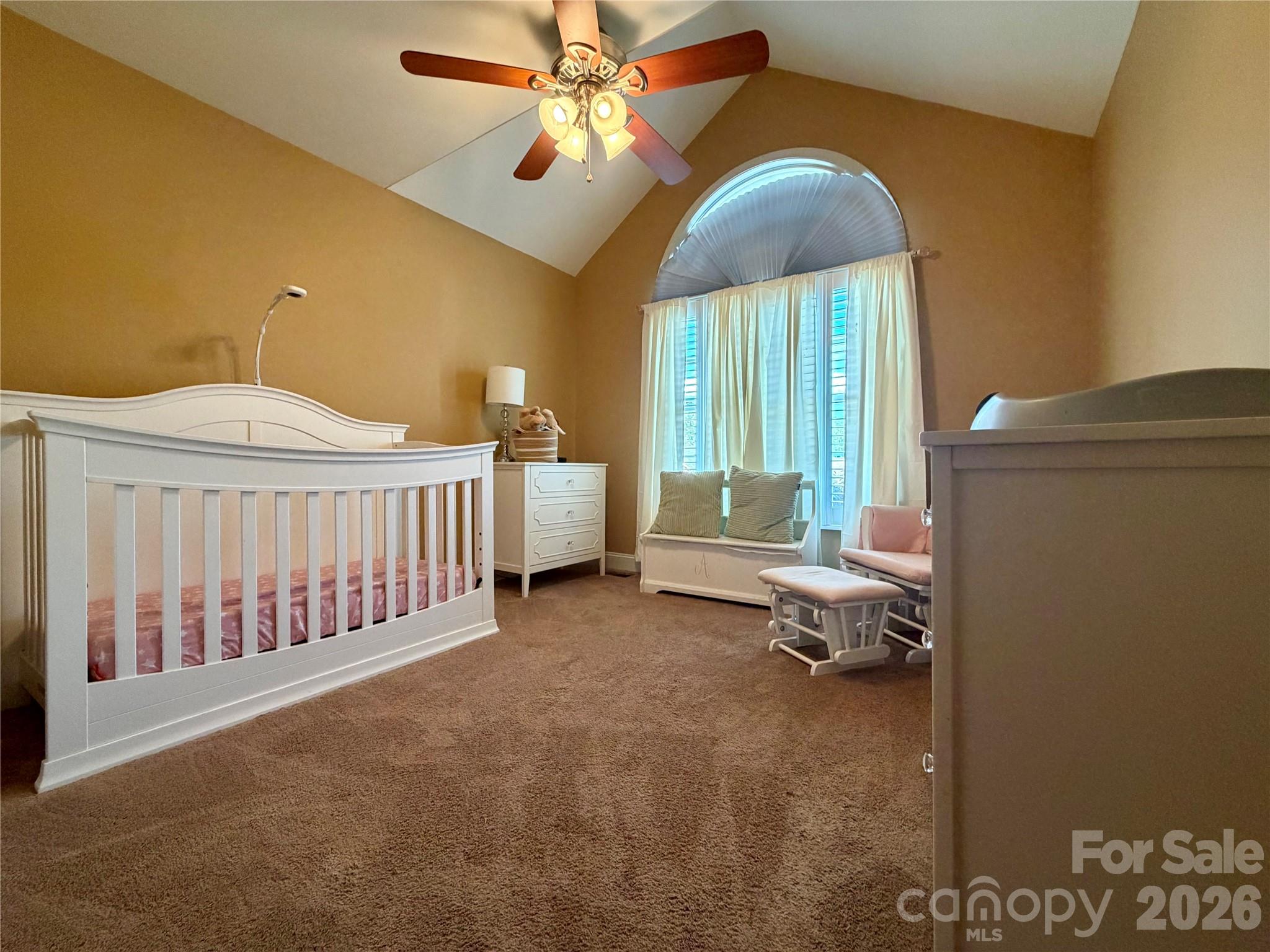 510 East Carpenter Street Maiden, NC 28650 - Photo 13 of 20 a bed room with a bed and a chandelier