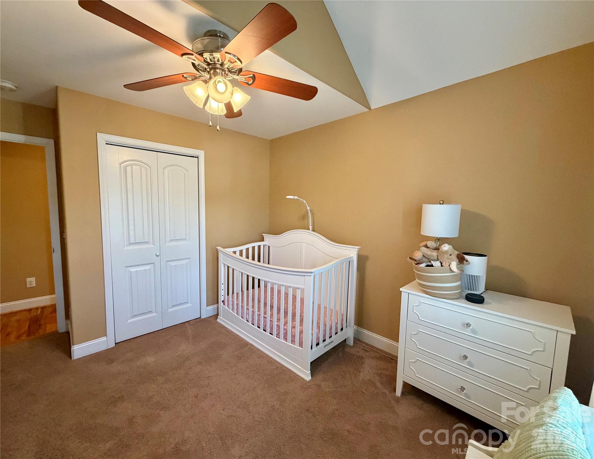 510 East Carpenter Street Maiden, NC 28650 - Photo 14 of 20 a bedroom with a bed and a chandelier