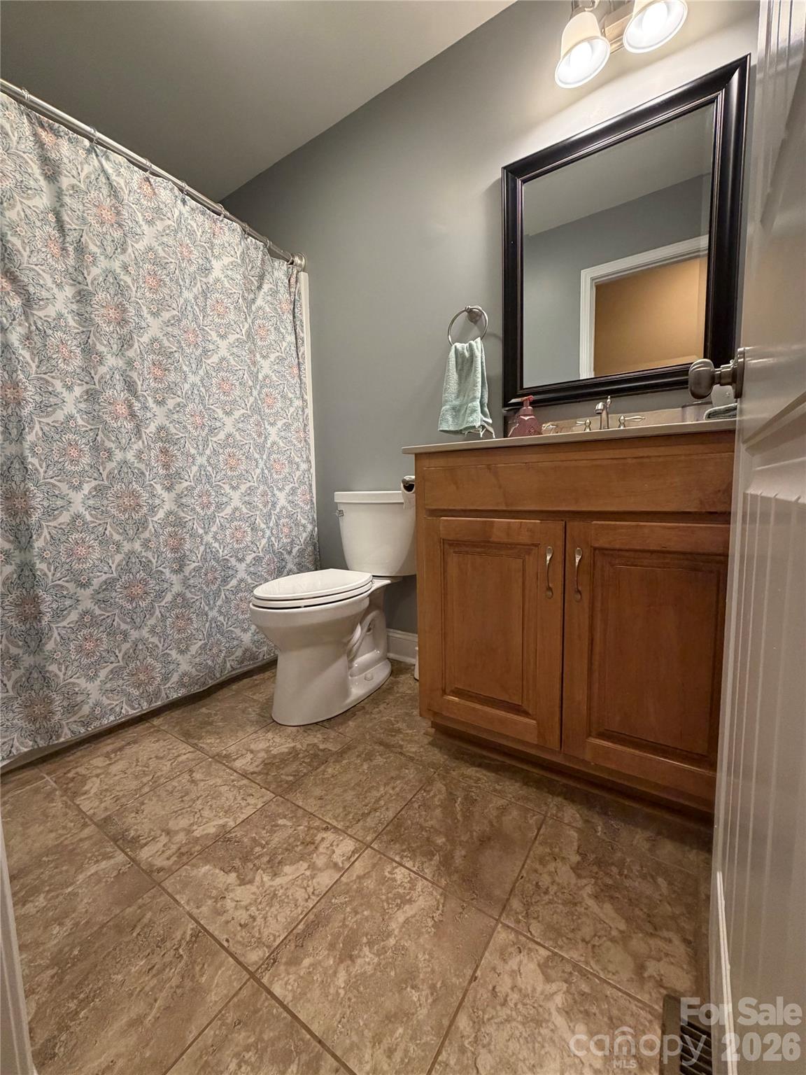 510 East Carpenter Street Maiden, NC 28650 - Photo 17 of 20 a bathroom with a toilet sink and mirror