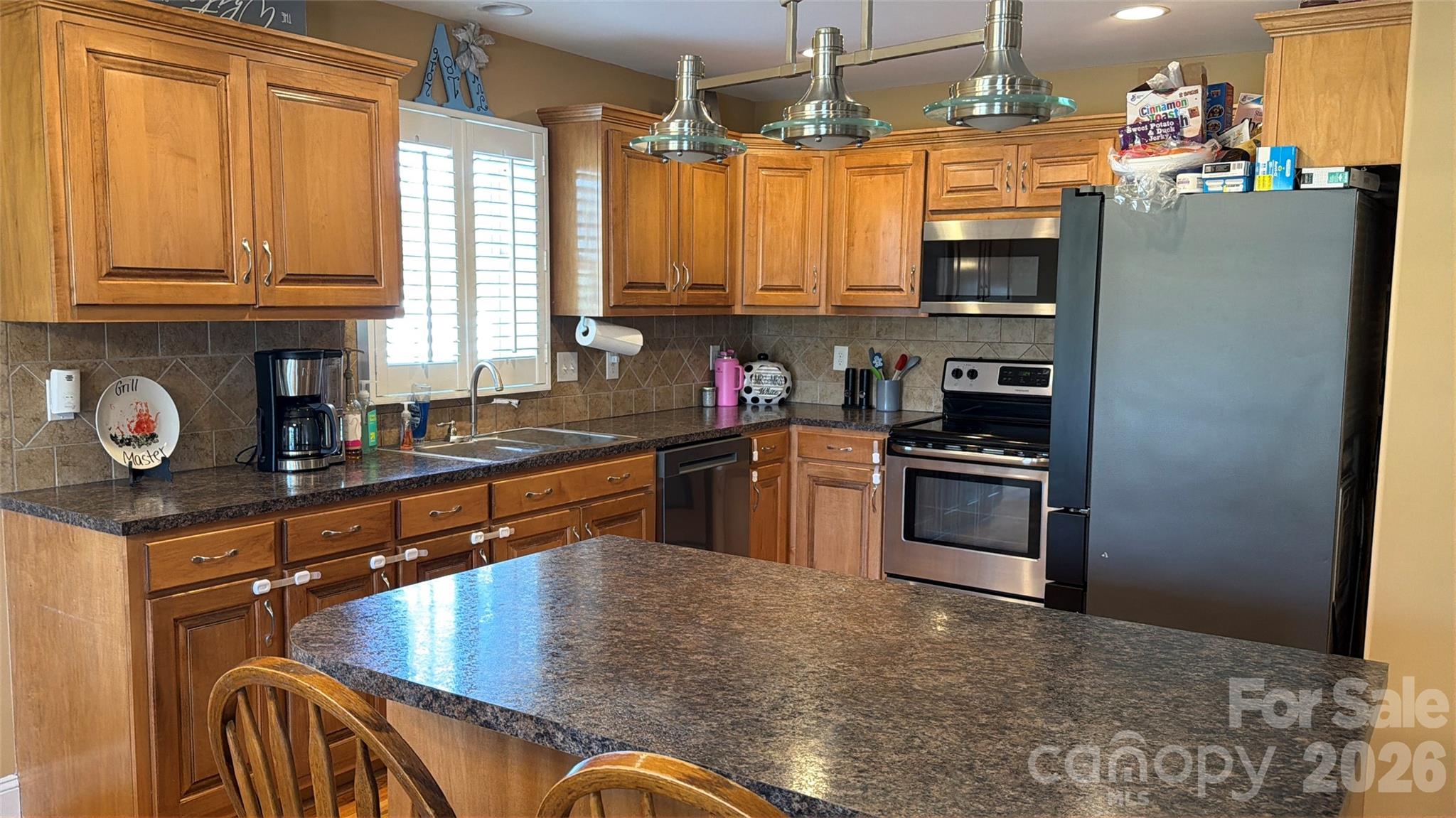 510 East Carpenter Street Maiden, NC 28650 - Photo 4 of 20 a kitchen with stainless steel appliances granite countertop a refrigerator a sink dishwasher a stove and a microwave oven on granite countertops