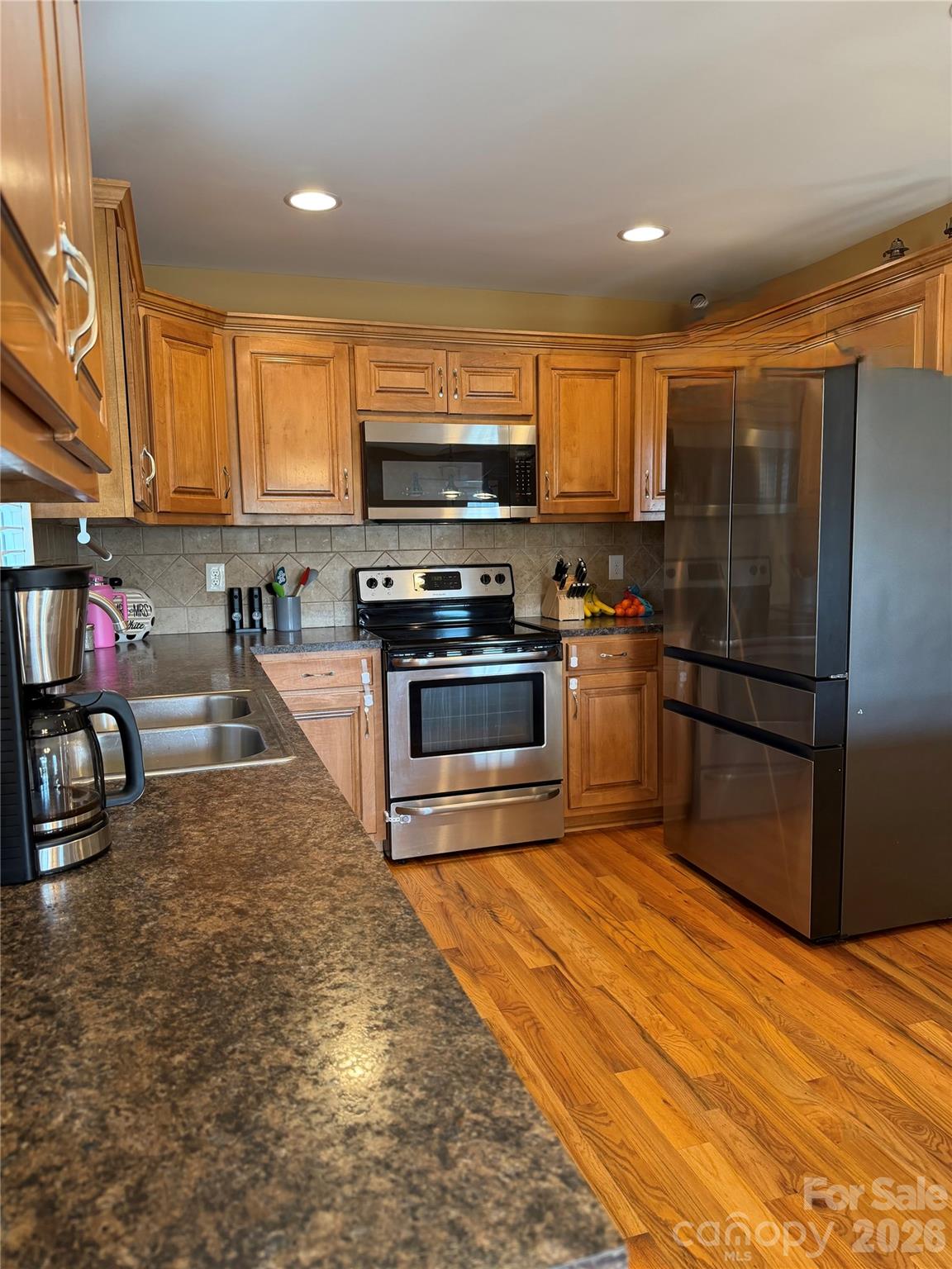 510 East Carpenter Street Maiden, NC 28650 - Photo 5 of 20 a kitchen with stainless steel appliances granite countertop a stove a sink and a refrigerator