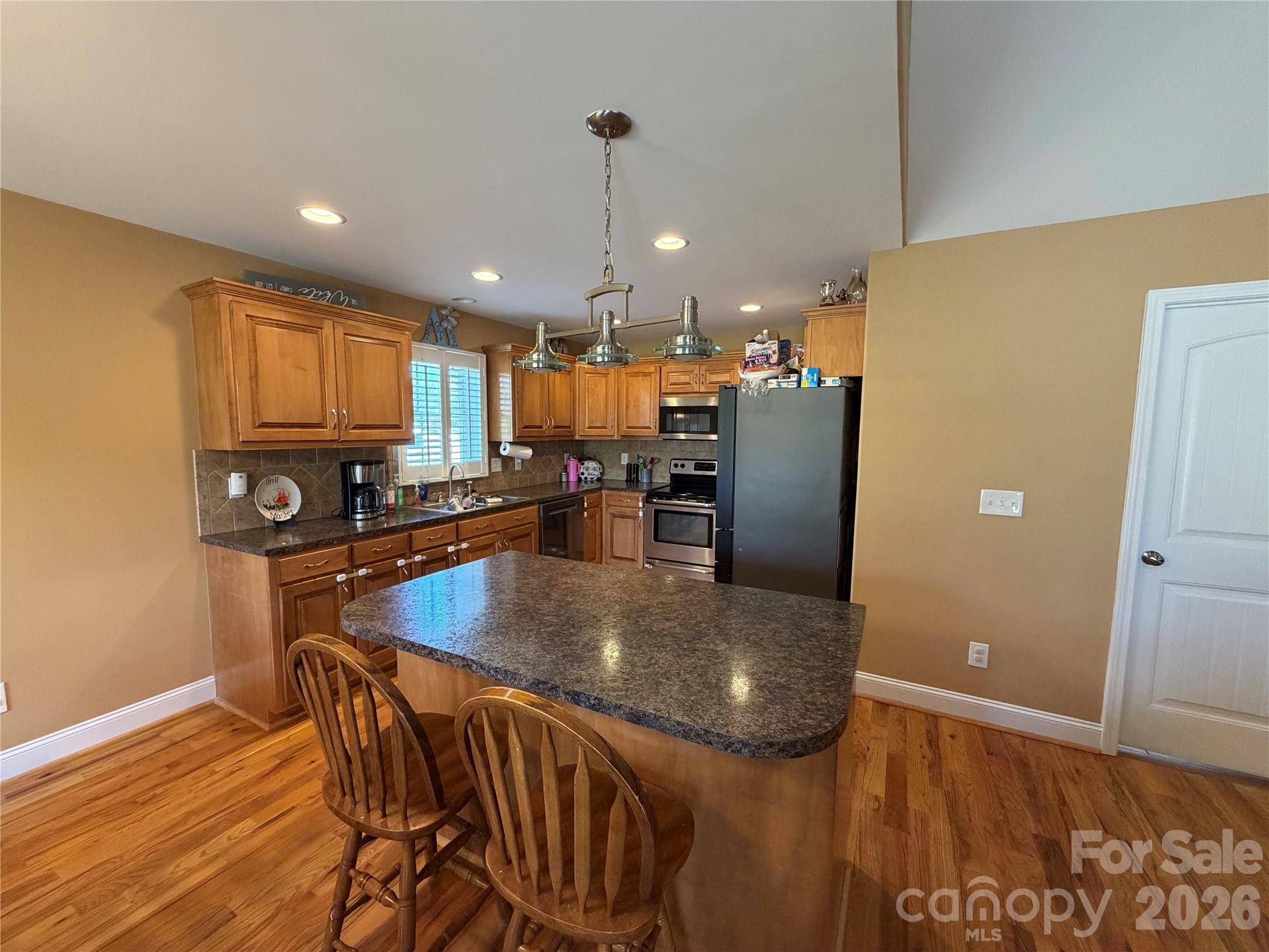 510 East Carpenter Street Maiden, NC 28650 - Photo 7 of 20 a kitchen with stainless steel appliances granite countertop a refrigerator a stove top oven a sink and dishwasher