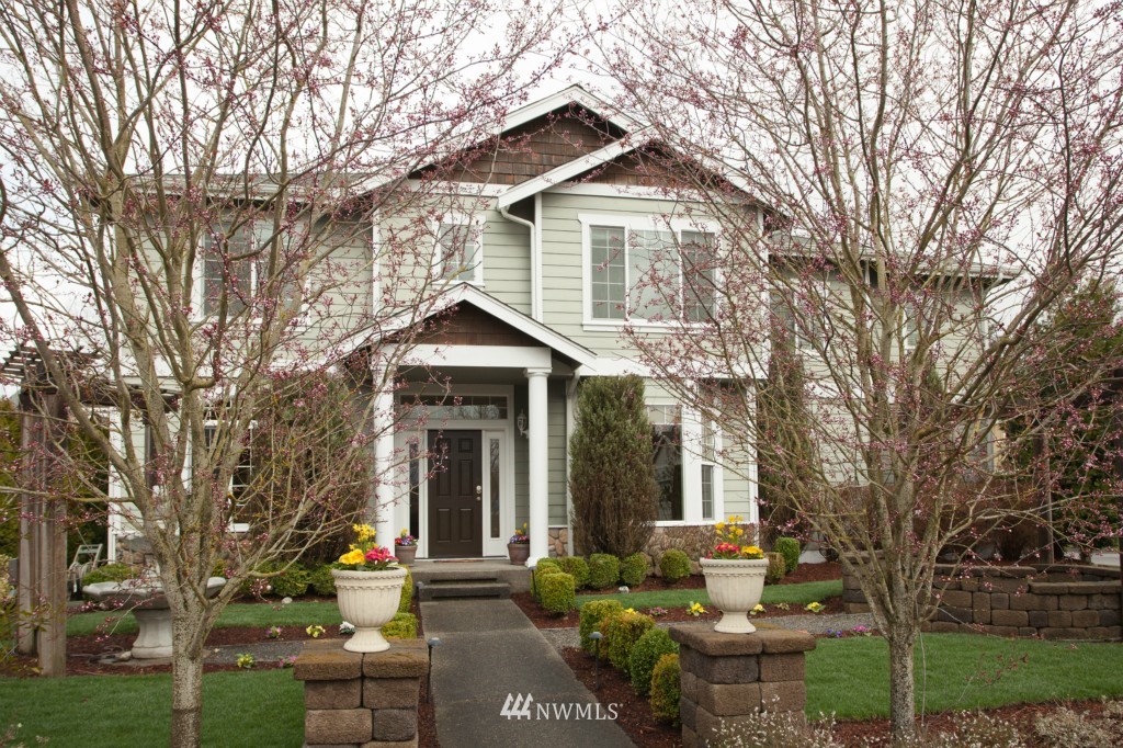 a front view of a house with garden