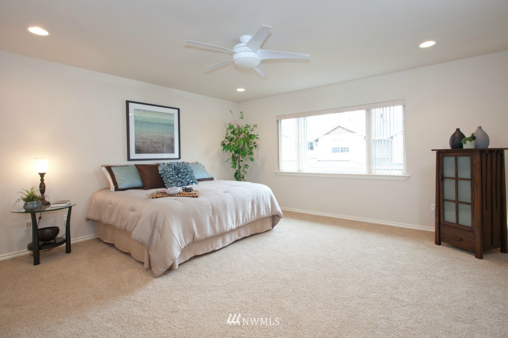 4806 Northeast 20th Place Renton, WA 98059 - Photo 11 of 17 a spacious bedroom with a bed and a chandelier
