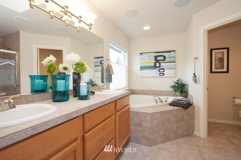 4806 Northeast 20th Place Renton, WA 98059 - Photo 13 of 17 a bathroom with a granite countertop sink a large mirror and a bathtub