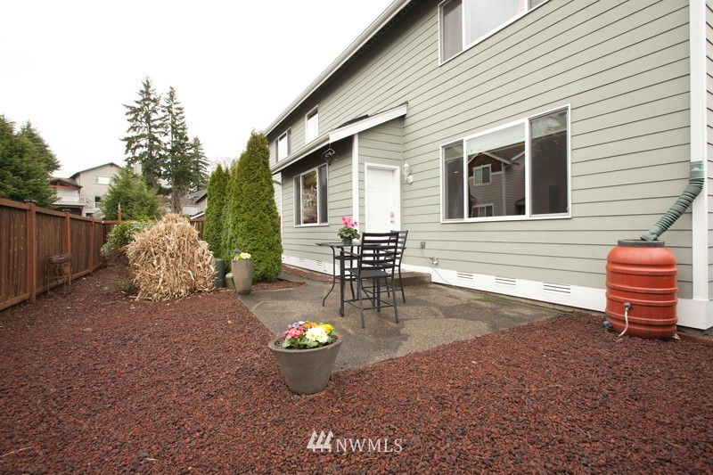 4806 Northeast 20th Place Renton, WA 98059 - Photo 17 of 17 a view of a backyard with table and chairs and potted plants