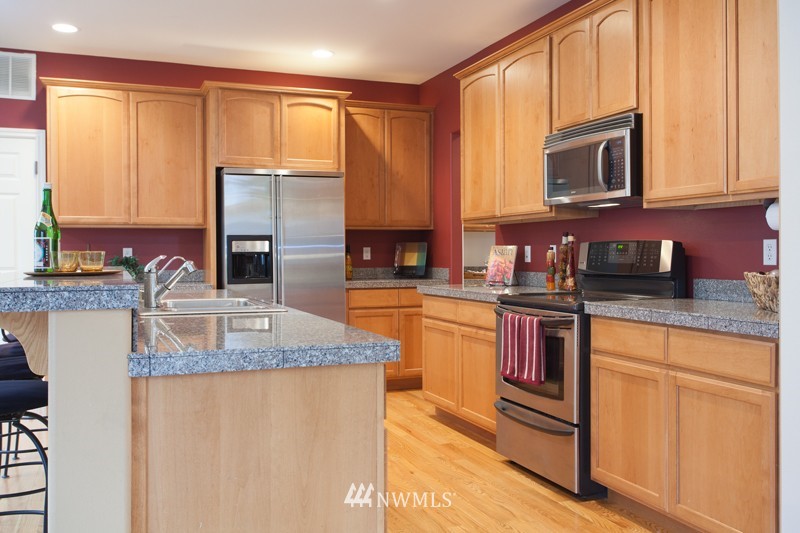 4806 Northeast 20th Place Renton, WA 98059 - Photo 4 of 17 a kitchen with granite countertop a sink stove and microwave