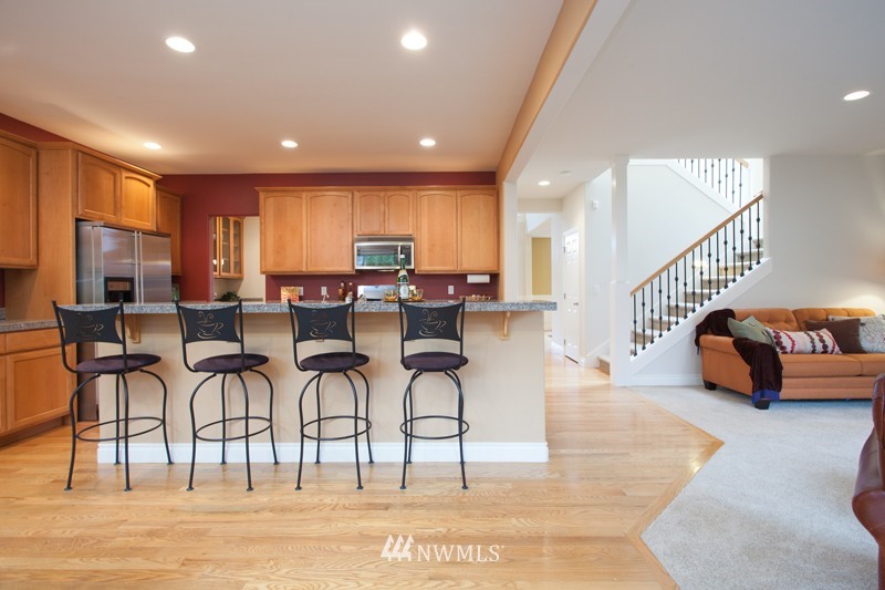 4806 Northeast 20th Place Renton, WA 98059 - Photo 6 of 17 a living room with furniture and a dining table with kitchen view