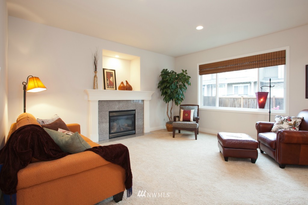 4806 Northeast 20th Place Renton, WA 98059 - Photo 10 of 17 a living room with furniture and a fireplace