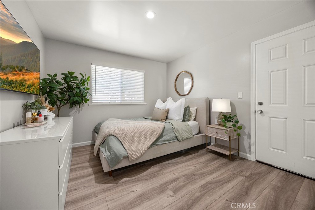 11629 185th Street Artesia, CA 90701 - Photo 13 of 20 a bedroom with a bed and a potted plant